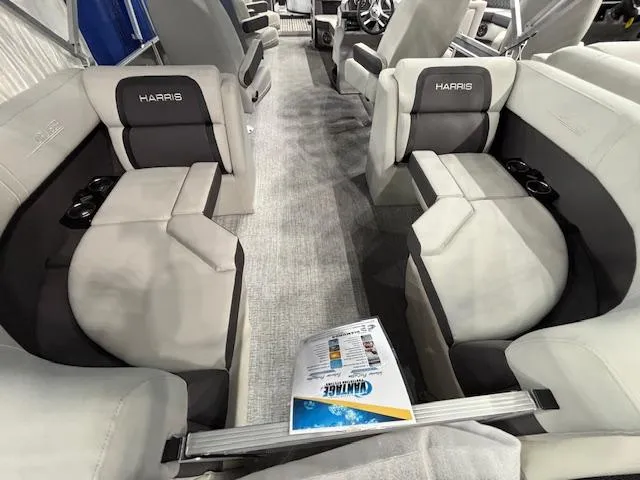 Slide: The Image of 2025 Harris Cruiser 230 interior with plush seating and cup holders. - 14