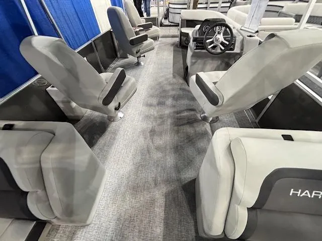 Slide: The Image of Interior of 2025 Harris Cruiser 230 boat with gray seating and steering wheel. - 15