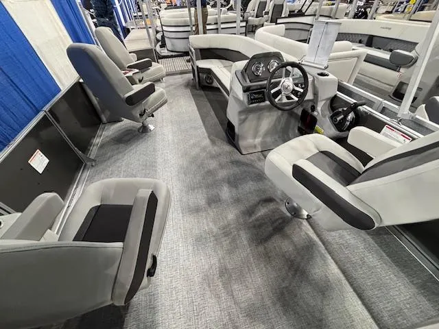 Slide: The Image of 2025 Harris Cruiser 230 interior with modern seating and steering console. - 16