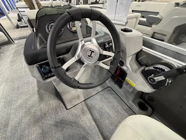 Slide: The Image of 2025 Harris Cruiser 230 boat steering wheel and dashboard interior. - 17