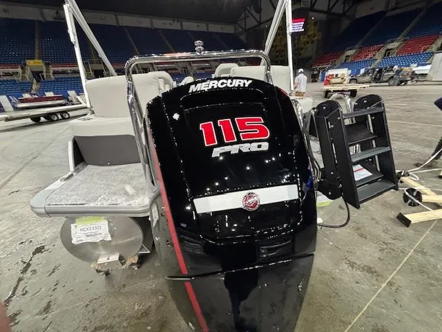 Slide: The Image of 2025 Harris Cruiser 230 with Mercury 115 Pro engine in indoor setting. - 5