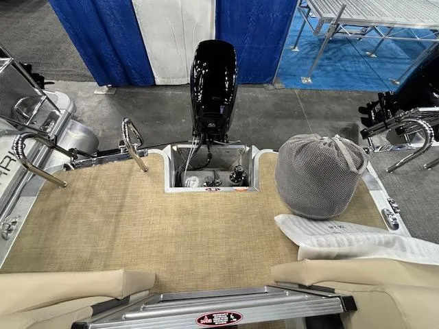 Slide: The Image of 2025 Harris Cruiser 190 boat interior with motor and seating area. - 11