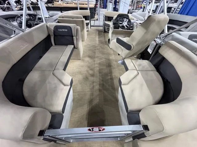 Slide: The Image of 2025 Harris Cruiser 190 pontoon boat interior with beige seating and steering console. - 15