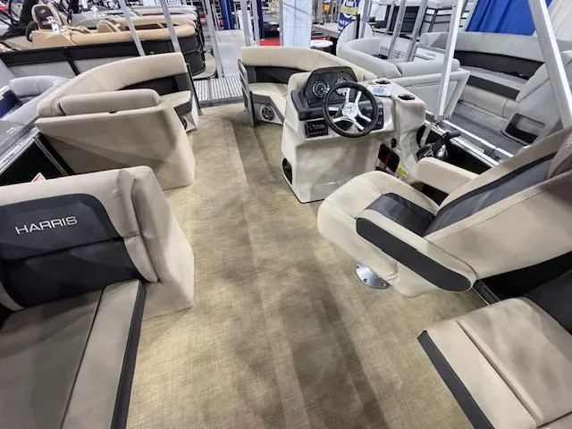 Slide: The Image of Interior of 2025 Harris Cruiser 190 boat with beige seating and modern steering console. - 16