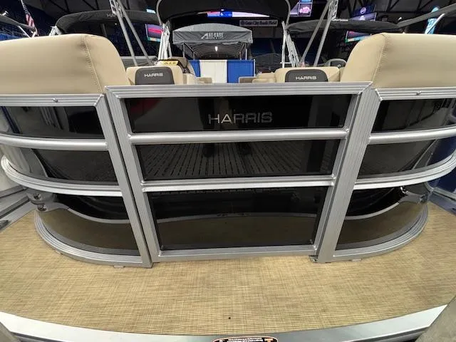 Slide: The Image of 2025 Harris Cruiser 190 pontoon boat, rear view with beige seating and sleek design. - 4