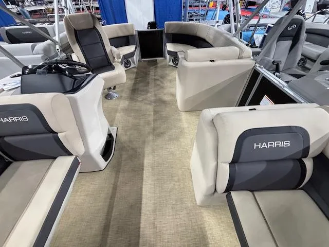 Slide: The Image of Interior of 2025 Harris Cruiser 190 pontoon boat with beige seating and steering console. - 6