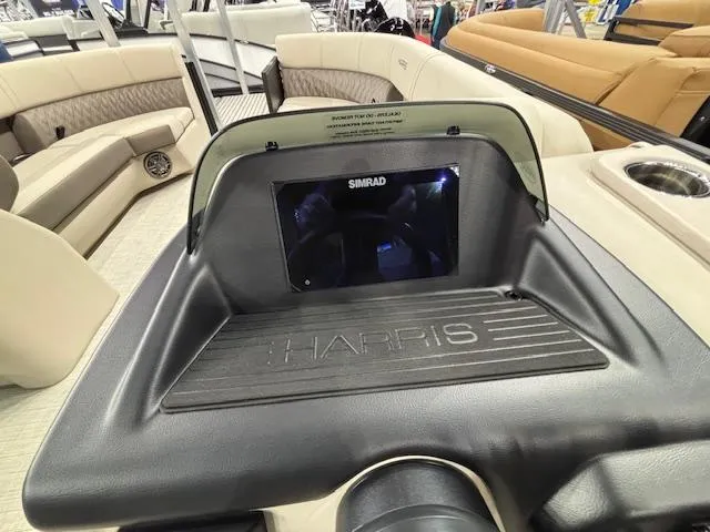 Slide: The Image of 2025 Harris SUNLINER 230 SLDH dashboard with Simrad display and luxurious seating. - 11