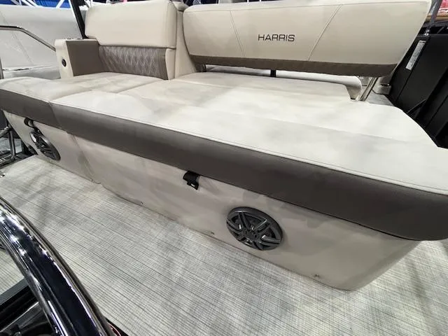 Slide: The Image of 2025 Harris SUNLINER 230 SLDH boat interior with cushioned seating and built-in speakers. - 17