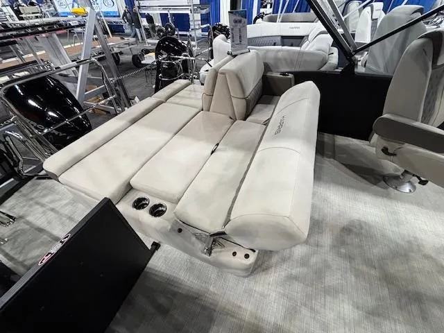 Slide: The Image of 2025 Harris SUNLINER 230 SLDH boat interior with beige seating and cup holders. - 20