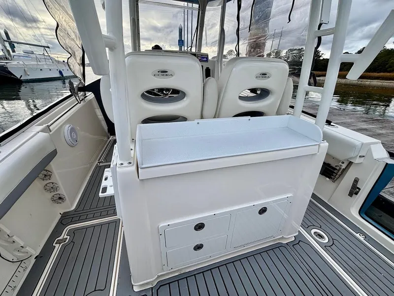 Slide: The Image of 2019 Cobia 301 Center Console boat interior with seating and storage compartments. - 9