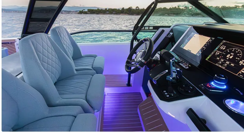 Slide: The Image of 2025 Saxdor 320 GTO boat interior with modern dashboard and illuminated seating. - 13