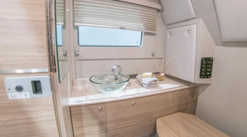 Slide: The Image of Interior of 2025 Saxdor 320 GTO featuring modern bathroom with glass sink and wooden cabinetry. - 17