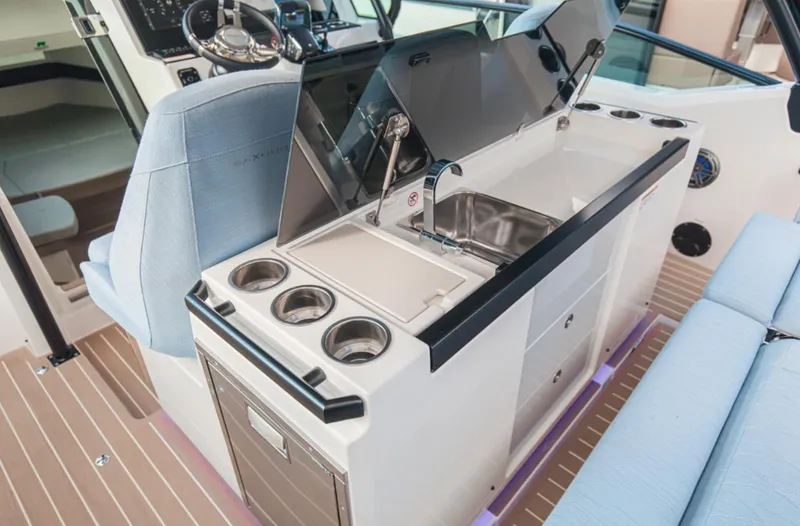 Slide: The Image of Interior view of 2025 Saxdor 320 GTO boat featuring a sleek kitchenette and seating area. - 3