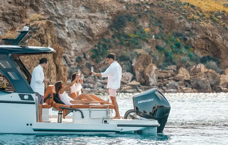 Slide: The Image of 2025 Saxdor 320 GTO boat with people enjoying a sunny day on the water. - 5