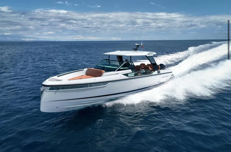 Slide: The Image of 2025 Saxdor 320 GTO cruising on open sea under clear skies. - 7