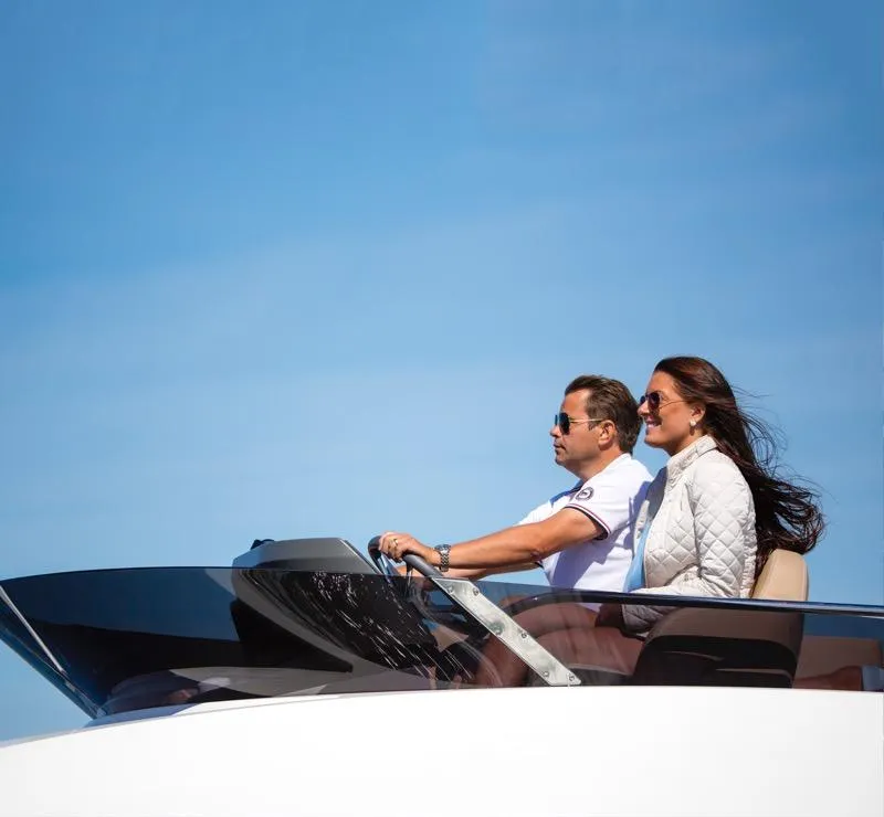 Slide: The Image of Couple enjoying a ride on a 2025 Nimbus 405 Flybridge yacht. - 3