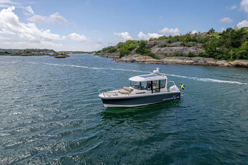 Slide: The Image of Nimbus Commuter 8 boat cruising in scenic waters, 2025 model. - 4