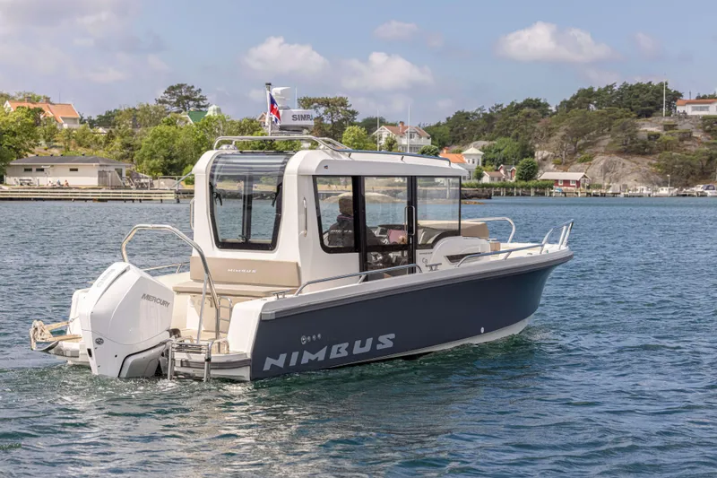 Slide: The Image of Nimbus Commuter 8 boat, 2025 model, cruising on a scenic waterway. - 9