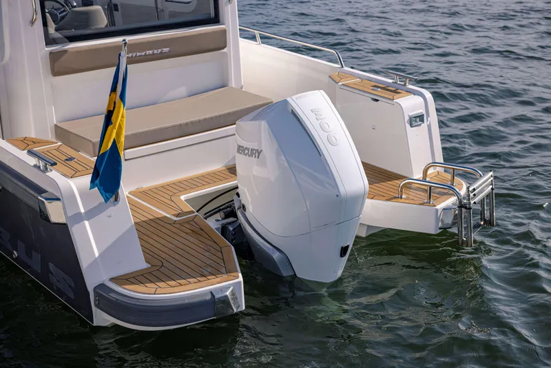 Slide: The Image of 2025 Nimbus Commuter 9 boat with Mercury outboard motor on water, featuring wooden deck and Swedish flag. - 11