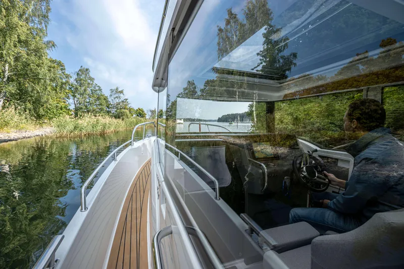 Slide: The Image of 2025 Nimbus Commuter 9 cruising through scenic waters, showcasing sleek design and modern features. - 13