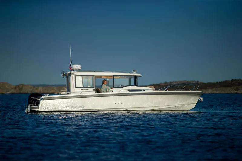 Slide: The Image of 2025 Nimbus Commuter 9 boat cruising on calm blue water. - 16