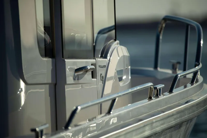 Slide: The Image of 2025 Nimbus Commuter 9 boat, sleek design with polished metal railings. - 17