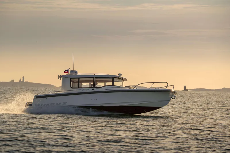 Slide: The Image of 2025 Nimbus Commuter 9 boat cruising on calm waters at sunset. - 18