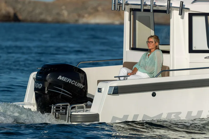 Slide: The Image of Woman relaxing on a 2025 Nimbus Commuter 9 boat with Mercury engine on the water. - 20