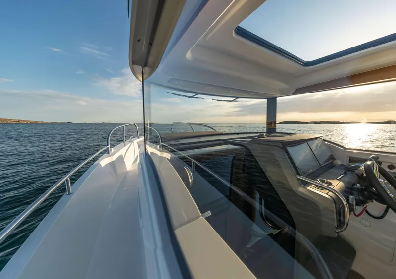 Slide: The Image of 2025 Nimbus Commuter 9 boat on open water, showcasing sleek design and modern cockpit. - 24