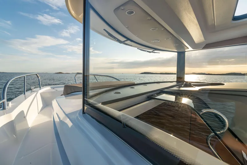 Slide: The Image of 2025 Nimbus Commuter 9 boat on water, showcasing sleek design and modern features. - 7