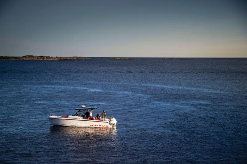 Slide: The Image of Nimbus Tender 8 boat cruising on open sea, 2025 model, under clear blue sky. - 10