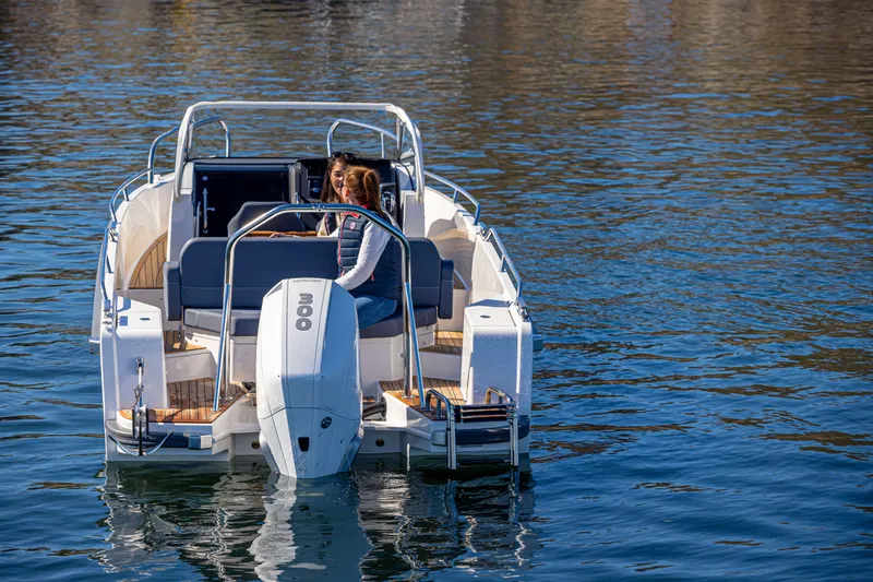 Slide: The Image of Nimbus Tender 8 boat, 2025 model, cruising on calm water with a person onboard. - 13