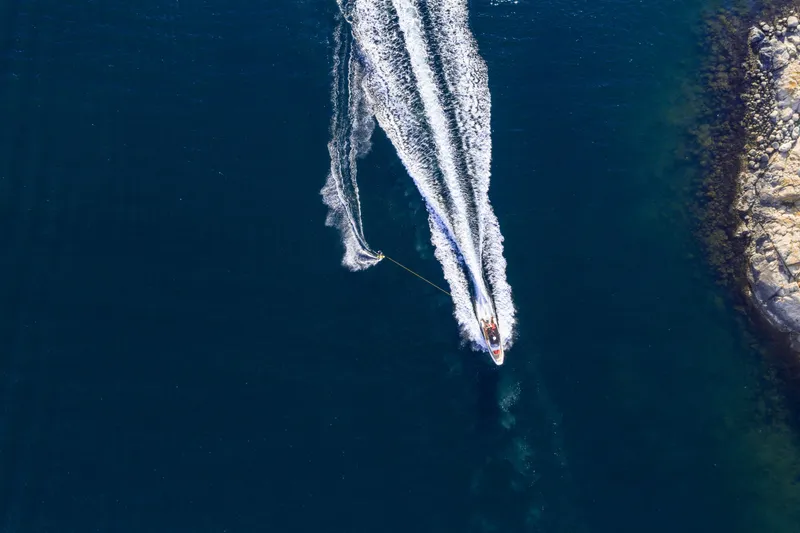 Slide: The Image of Aerial view of Nimbus Tender 8 boat cruising on deep blue water, 2025 model. - 14