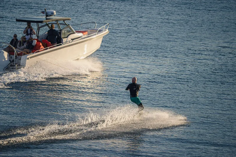 Slide: The Image of Man waterskiing behind 2025 Nimbus Tender 8 boat on a sunny day. - 15