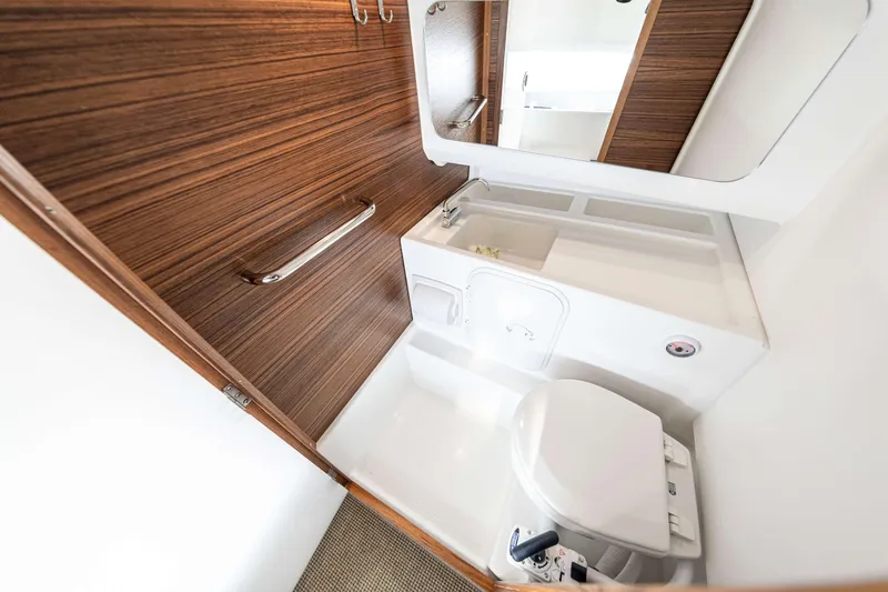 Slide: The Image of Modern bathroom interior of 2025 Nimbus Tender 8 boat, featuring wood paneling and compact design. - 25