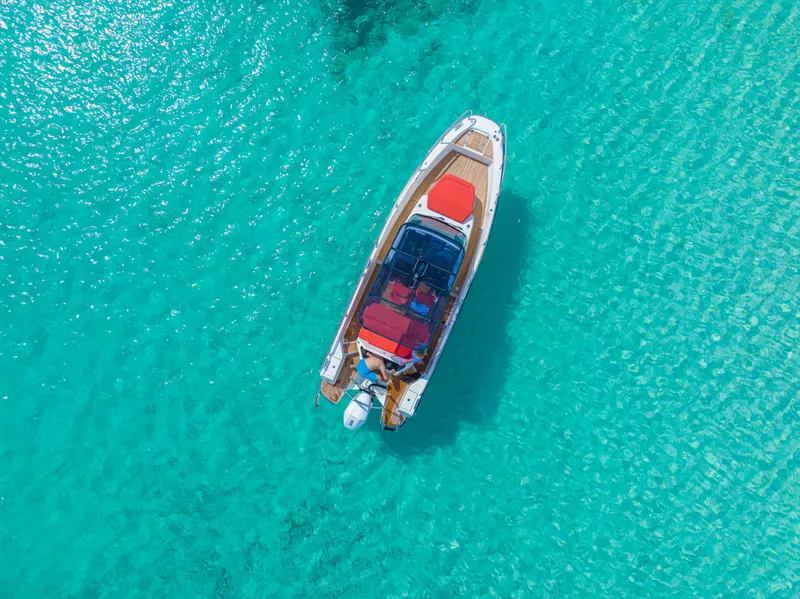 Slide: The Image of Aerial view of 2025 Nimbus Tender 8 boat on clear turquoise water. - 34