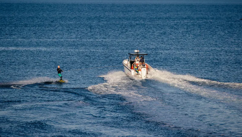 Slide: The Image of Wakeboarder being towed by Nimbus Tender 8 boat on open water, 2025 model. - 7