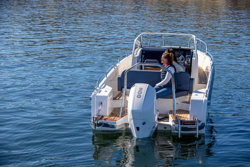 Slide: The Image of 2025 Nimbus Tender 8 boat on calm water, featuring modern design and powerful outboard motor. - 9