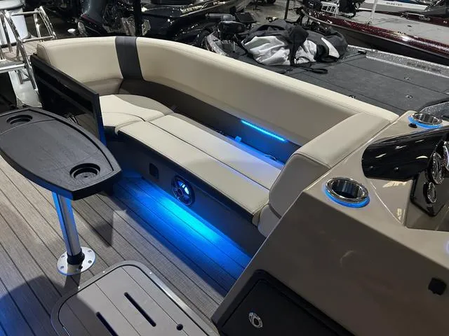 Slide: The Image of Luxurious seating area on 2025 SunCatcher Select 322SS boat with ambient blue lighting. - 10
