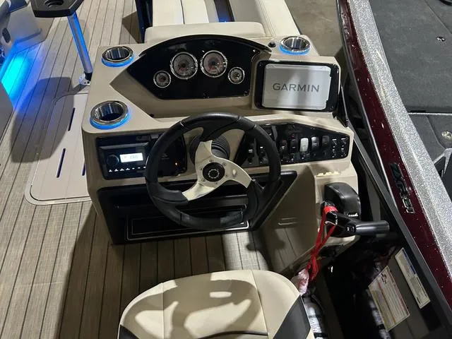 Slide: The Image of 2025 SunCatcher Select 322SS boat dashboard with Garmin navigation and Yamaha controls. - 11