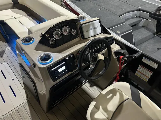 Slide: The Image of 2025 SunCatcher Select 322SS boat dashboard with Garmin navigation and Yamaha controls. - 12