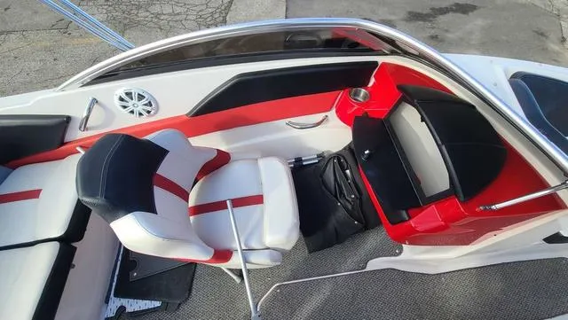 Slide: The Image of 2016 Four Winns H 180 SS boat interior with red and white seating and speaker. - 11