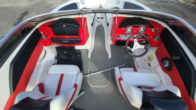 Slide: The Image of 2016 Four Winns H 180 SS boat interior with red and white seating and dashboard. - 12