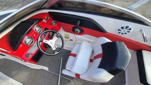 Slide: The Image of 2016 Four Winns H 180 SS boat interior with red dashboard and white seating. - 13