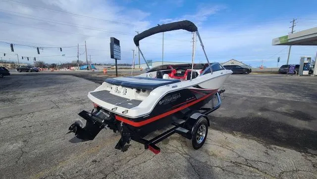 Slide: The Image of 2016 Four Winns H 180 SS boat on trailer in parking lot. - 3