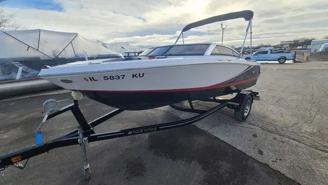 Slide: The Image of 2016 Four Winns H 180 SS boat on trailer, parked outdoors. - 8