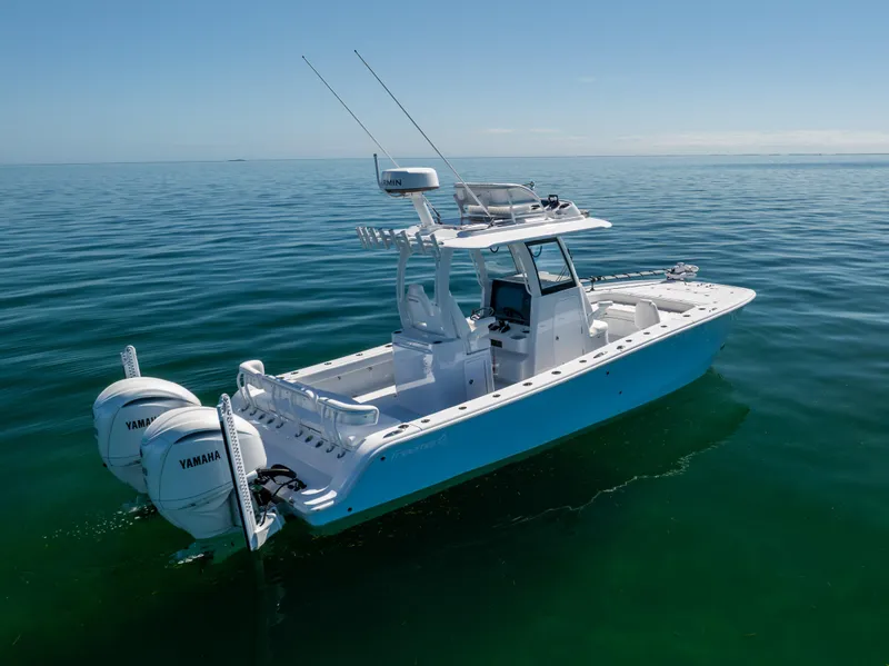 Slide: The Image of 2025 Freeman 28 boat with twin Yamaha engines on calm sea. - 10