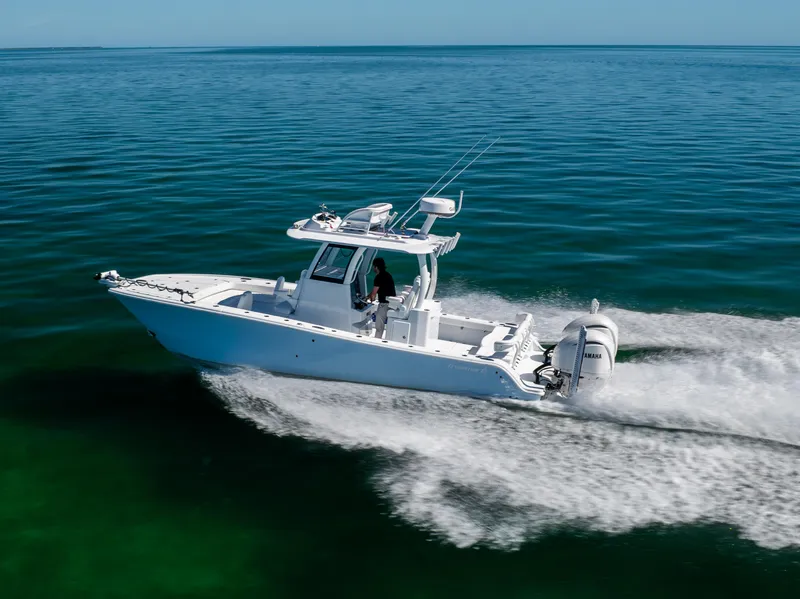 Slide: The Image of 2025 Freeman 28 boat cruising on clear blue ocean waters. - 13