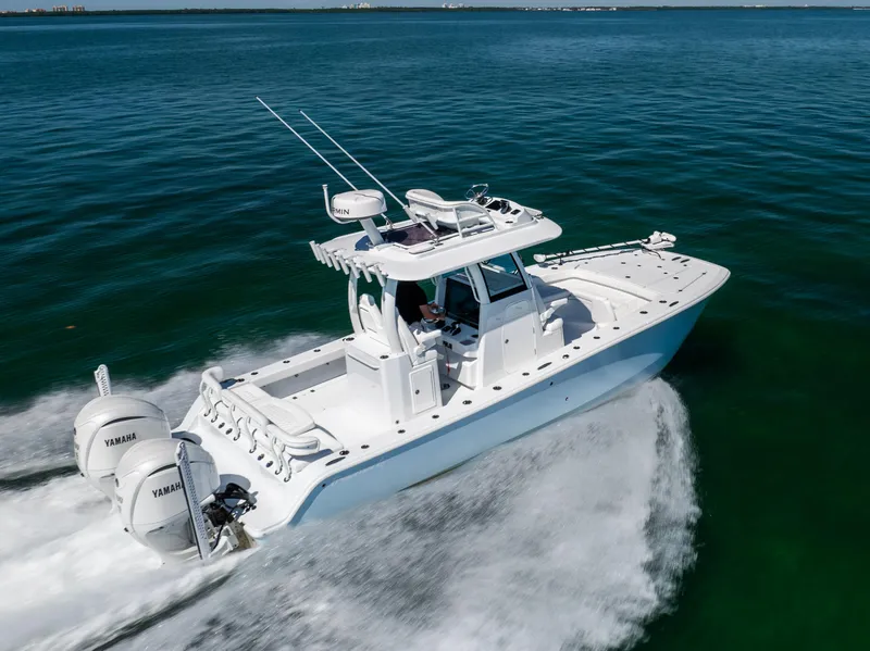 Slide: The Image of 2025 Freeman 28 boat cruising on open water with dual Yamaha engines. - 15
