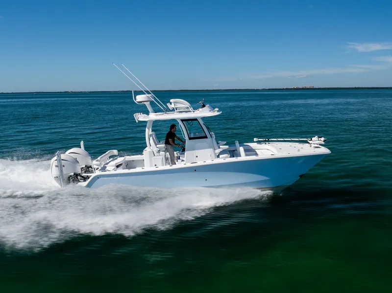 Slide: The Image of Freeman 28 boat cruising on open water, 2025 model, under clear blue sky. - 16